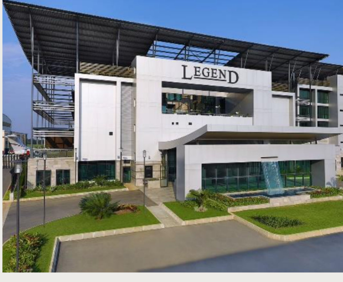 The white daytime facade and entrance of Legend Hotel at Murtala Muhammed International Airport