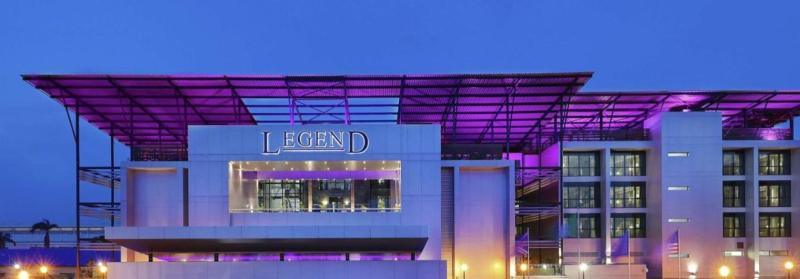 The illuminated facade of Legend Hotel Lagos Airport at night