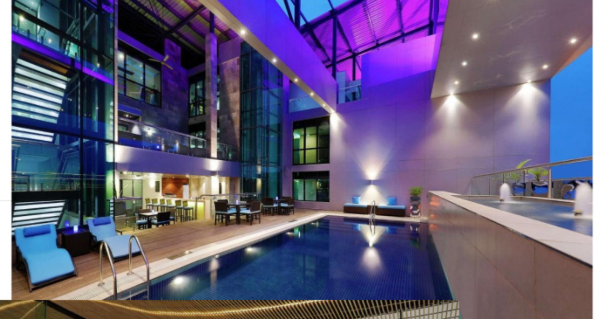 The indoor pool at Legend Hotel at night, bathed in purple ambient light